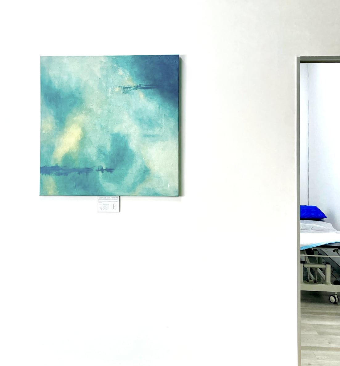 Textured abstract painting in soft blue and sandy tones, blending oceanic hues with warm earth textures.